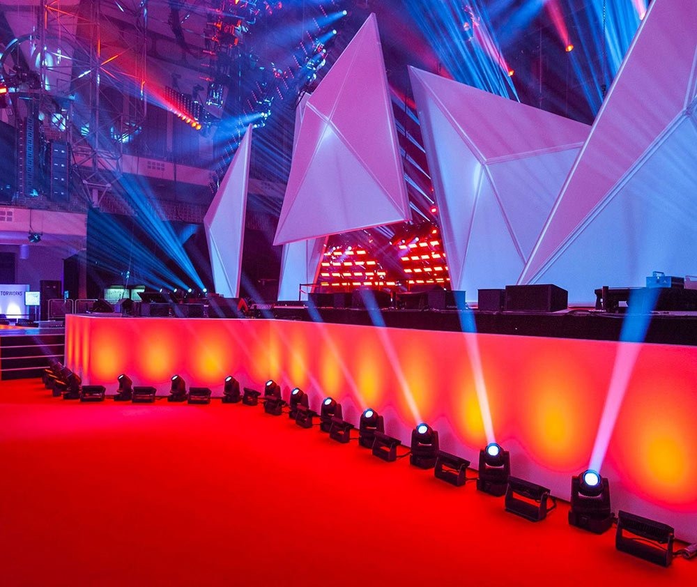 تصميم جناح مؤتمر احترافي من Bombina Events — إضاءة باردة، تخطيط وظيفي، وتركيز على الوضوح والاحترافية